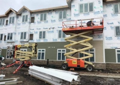 roofing-contractors-installing-tyvek-siding-in-commercial-building